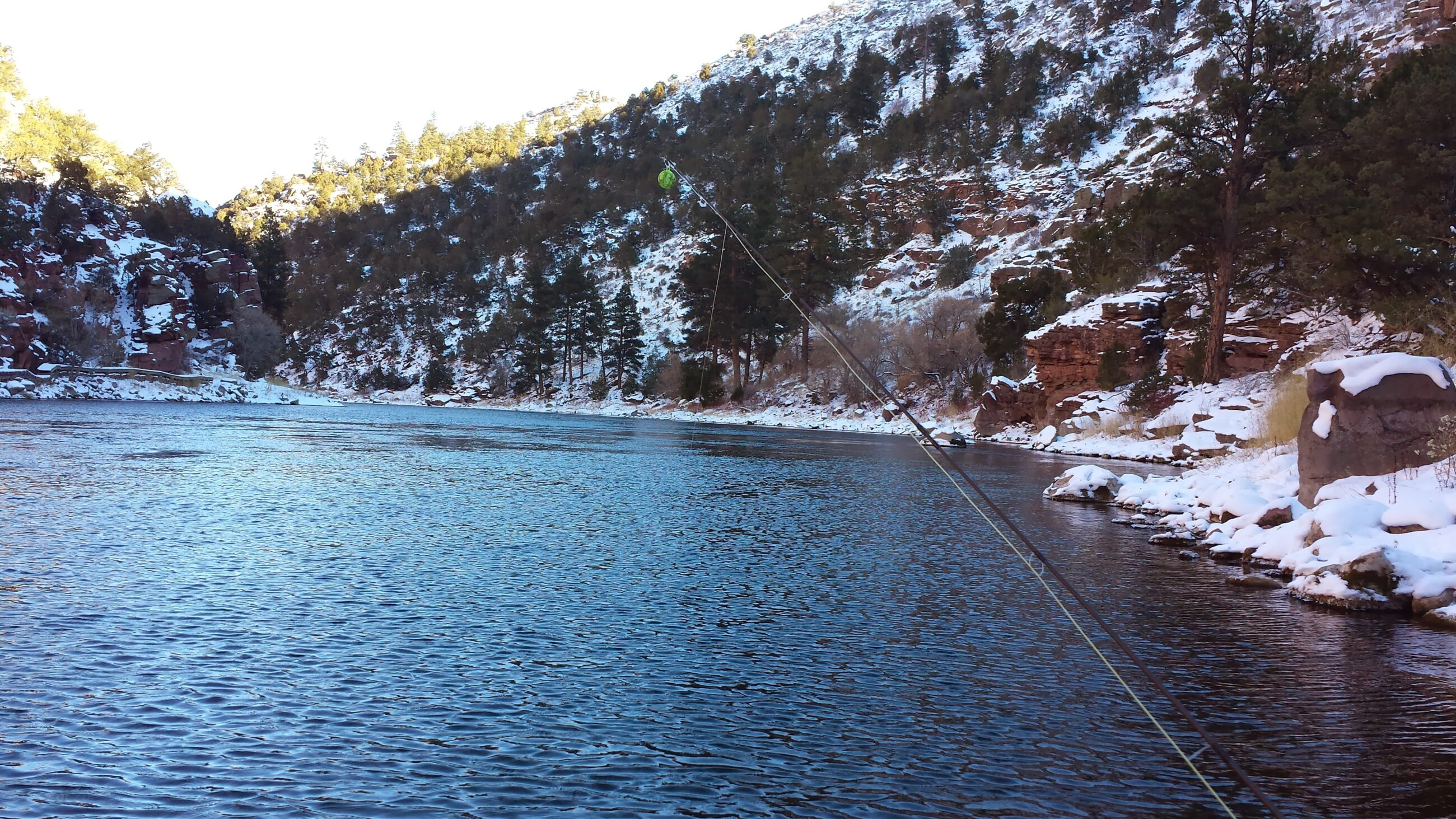 20131212_132720 Drift boat on the Green river pulled into a calm eddie to allow Green river fishing guide and 2 fly fishing guests to stretch their legs on the shore & to cast dry flies to trophy size trout swimming in the Gin Clear waters of the Green river feeding on a hatch of Blue Wing Olive May Flies.