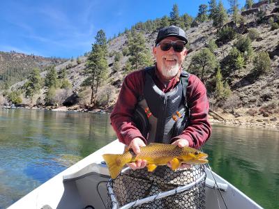 Dutch John Resort Fly Fishing Wild Brown Trout Drift Boat Fly fishing guest of Dutch John Resort Fishing Guides releasing large green river wild trout into the tail waters below Flaming Gorge Dam into the Green River